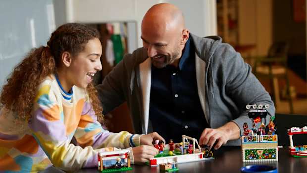 Two people playing with Lego's Icons of Play set.